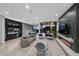 Open-concept living room featuring modern fireplace, stylish seating, and a scenic outdoor view at 383 Solitude Peak Ln, Henderson, NV 89012