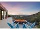 Backyard patio with comfortable seating around a fire pit and gorgeous mountain views at 383 Solitude Peak Ln, Henderson, NV 89012