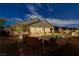 Experience outdoor living in this backyard featuring a paver patio, lush artificial grass, and nighttime ambiance at 3906 Jacob Lake Cir, Las Vegas, NV 89118