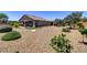 Beautifully landscaped backyard with artificial turf, mature trees, and desert landscaping at 3906 Jacob Lake Cir, Las Vegas, NV 89118