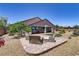 Expansive backyard with brick patio, seating area, and lush landscaping at 3906 Jacob Lake Cir, Las Vegas, NV 89118