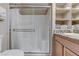 Bright bathroom boasts glass enclosed shower, granite countertop and convenient built in shelves at 3906 Jacob Lake Cir, Las Vegas, NV 89118