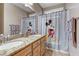 bathroom featuring double sinks, granite countertops, and a shower curtain with a Mickey Mouse design at 3906 Jacob Lake Cir, Las Vegas, NV 89118
