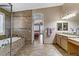 Spacious bathroom showcasing a tub, shower, dual vanity, and tiled floor at 3906 Jacob Lake Cir, Las Vegas, NV 89118
