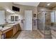 Main bathroom showcasing dual sinks, walk-in shower, and tiled flooring at 3906 Jacob Lake Cir, Las Vegas, NV 89118