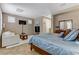 Inviting bedroom area with sitting area, television, large mirror and soft, neutral tones at 3906 Jacob Lake Cir, Las Vegas, NV 89118