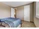 Bedroom features tile floors, neutral walls, and a comfortable-looking bed at 3906 Jacob Lake Cir, Las Vegas, NV 89118