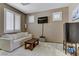 A sitting area is featured in this light filled bedroom with white trim and neutral walls at 3906 Jacob Lake Cir, Las Vegas, NV 89118