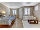 Well-lit and spacious bedroom area complete with full bed, couch and small dining area at 3906 Jacob Lake Cir, Las Vegas, NV 89118