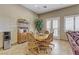A quaint dining room featuring a light wood table and chairs, a decorative hutch, and natural light at 3906 Jacob Lake Cir, Las Vegas, NV 89118