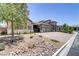 Charming exterior view showcasing desert landscaping, a three-car garage and beautiful architectural details at 3906 Jacob Lake Cir, Las Vegas, NV 89118