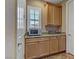 A well-lit kitchenette with light wood cabinets, granite countertops, and stainless steel microwave at 3906 Jacob Lake Cir, Las Vegas, NV 89118