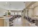 Open layout with kitchen island, bar seating, and living room with fireplace and ceiling fan at 3906 Jacob Lake Cir, Las Vegas, NV 89118