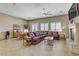 Inviting living room with a cozy fireplace, ample seating, and tile floors at 3906 Jacob Lake Cir, Las Vegas, NV 89118