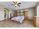 Spacious main bedroom featuring tile floors, ceiling fan, and adjoining bathroom at 3906 Jacob Lake Cir, Las Vegas, NV 89118