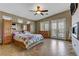 A cozy main bedroom featuring a ceiling fan, tile flooring, a fireplace, and outdoor access at 3906 Jacob Lake Cir, Las Vegas, NV 89118