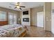 Bright main bedroom boasting a fireplace, television, and access to a balcony at 3906 Jacob Lake Cir, Las Vegas, NV 89118