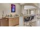 Home wet bar with granite counter and seating, perfect for entertaining guests at 3906 Jacob Lake Cir, Las Vegas, NV 89118