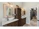 Elegant bathroom with double sink vanity, white marble countertops and a view to hallway at 3950 Candleglow Ct, Las Vegas, NV 89147