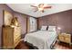 Cozy bedroom features hardwood floors, comfortable bed, and natural light from the window at 3950 Candleglow Ct, Las Vegas, NV 89147