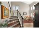 Elegant entryway with hardwood stairs, soaring ceilings, and a view into the adjacent living room at 3950 Candleglow Ct, Las Vegas, NV 89147