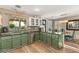 Charming kitchen features dark granite countertops, stainless steel appliances, and green cabinetry at 3950 Candleglow Ct, Las Vegas, NV 89147