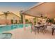 Comfortable covered patio with outdoor dining and lounge seating near the pool at 3950 Candleglow Ct, Las Vegas, NV 89147