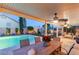 Relaxing covered patio with dining area and lounge seating overlooking the pool at 3950 Candleglow Ct, Las Vegas, NV 89147