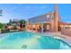 Sparkling pool and spa with covered patio and outdoor dining area at 3950 Candleglow Ct, Las Vegas, NV 89147