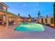 A large swimming pool with a connected hot tub and ample patio space for entertaining guests at 3950 Candleglow Ct, Las Vegas, NV 89147