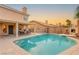 A large swimming pool with a connected hot tub and ample patio space for entertaining guests at 3950 Candleglow Ct, Las Vegas, NV 89147