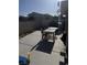 Backyard concrete patio with outdoor table and grill at 4607 Chestnut Blaze Dr, North Las Vegas, NV 89032