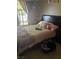 Cozy bedroom featuring a dark headboard, neutral bedding and a bright window at 4607 Chestnut Blaze Dr, North Las Vegas, NV 89032