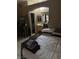 Cluttered bedroom with natural lighting, vanity, and adjacent bathroom access at 4607 Chestnut Blaze Dr, North Las Vegas, NV 89032
