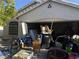 Exterior shot of home featuring a garage filled with furniture and other household items at 4607 Chestnut Blaze Dr, North Las Vegas, NV 89032