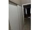 Hallway featuring a sliding door closet and leads to another room with natural light at 4607 Chestnut Blaze Dr, North Las Vegas, NV 89032