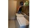Functional laundry room with washer, dryer, and overhead shelving at 4607 Chestnut Blaze Dr, North Las Vegas, NV 89032