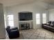 Bright living room features tile flooring, neutral paint, and a built-in entertainment center at 4607 Chestnut Blaze Dr, North Las Vegas, NV 89032