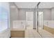 Bright bathroom featuring a soaking tub, tiled floor, and a glass door shower at 5019 Lancaster Dr, Las Vegas, NV 89120