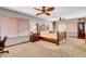 Spacious main bedroom with ceiling fans, carpeting and natural light at 5019 Lancaster Dr, Las Vegas, NV 89120