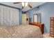 Inviting bedroom with blue walls, floral bedding, and a wooden dresser, creating a serene and comfortable atmosphere at 5019 Lancaster Dr, Las Vegas, NV 89120