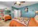 Stylish bedroom with a butterfly-themed bedspread, blue walls, and mirrored closet, creating a vibrant space at 5019 Lancaster Dr, Las Vegas, NV 89120