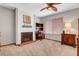 Cozy bedroom with built-in desk, fireplace, and a ceiling fan at 5019 Lancaster Dr, Las Vegas, NV 89120