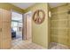 Hallway with tiled floors and multiple doorways, leading to a pool area and offering ample storage at 5019 Lancaster Dr, Las Vegas, NV 89120