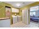 Well-equipped laundry room with white appliances, cabinets, and tiled floors, flowing into an adjacent living area at 5019 Lancaster Dr, Las Vegas, NV 89120