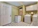 Functional laundry room with white appliances, tile floors, and ample storage, perfect for everyday convenience at 5019 Lancaster Dr, Las Vegas, NV 89120