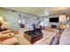 Spacious living room featuring a large sofa, cozy seating, and a staircase to the upper level at 5019 Lancaster Dr, Las Vegas, NV 89120