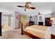Cozy bedroom featuring a fireplace, built-in desk, and modern ceiling fan at 5019 Lancaster Dr, Las Vegas, NV 89120