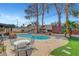 In-ground pool in backyard with mature trees and patio furniture at 5019 Lancaster Dr, Las Vegas, NV 89120