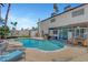 An in-ground pool in a backyard, with patio furniture and an attached covered patio at 5019 Lancaster Dr, Las Vegas, NV 89120